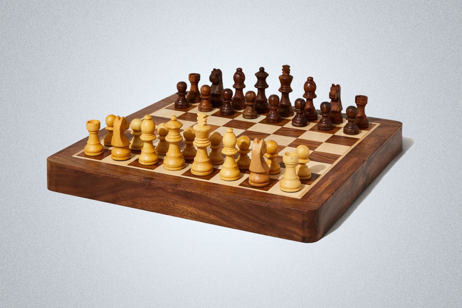 a wooden magnetic chess board from Bespoke Post on a grey background