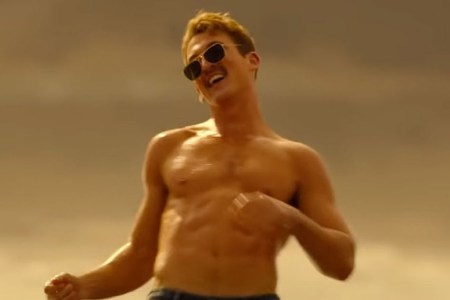 a picture of Miles Teller in Top Gun:Maverick shirtless, dancing and wearing the Ray-Ban Caravan sunglasses