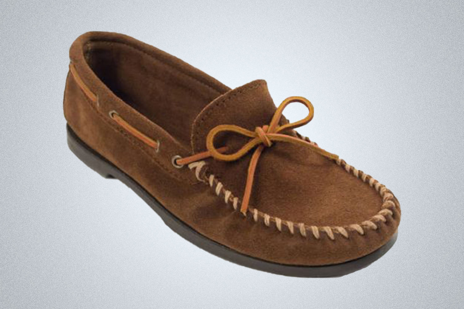 a suede brown Minnetonka moccasin on a grey background