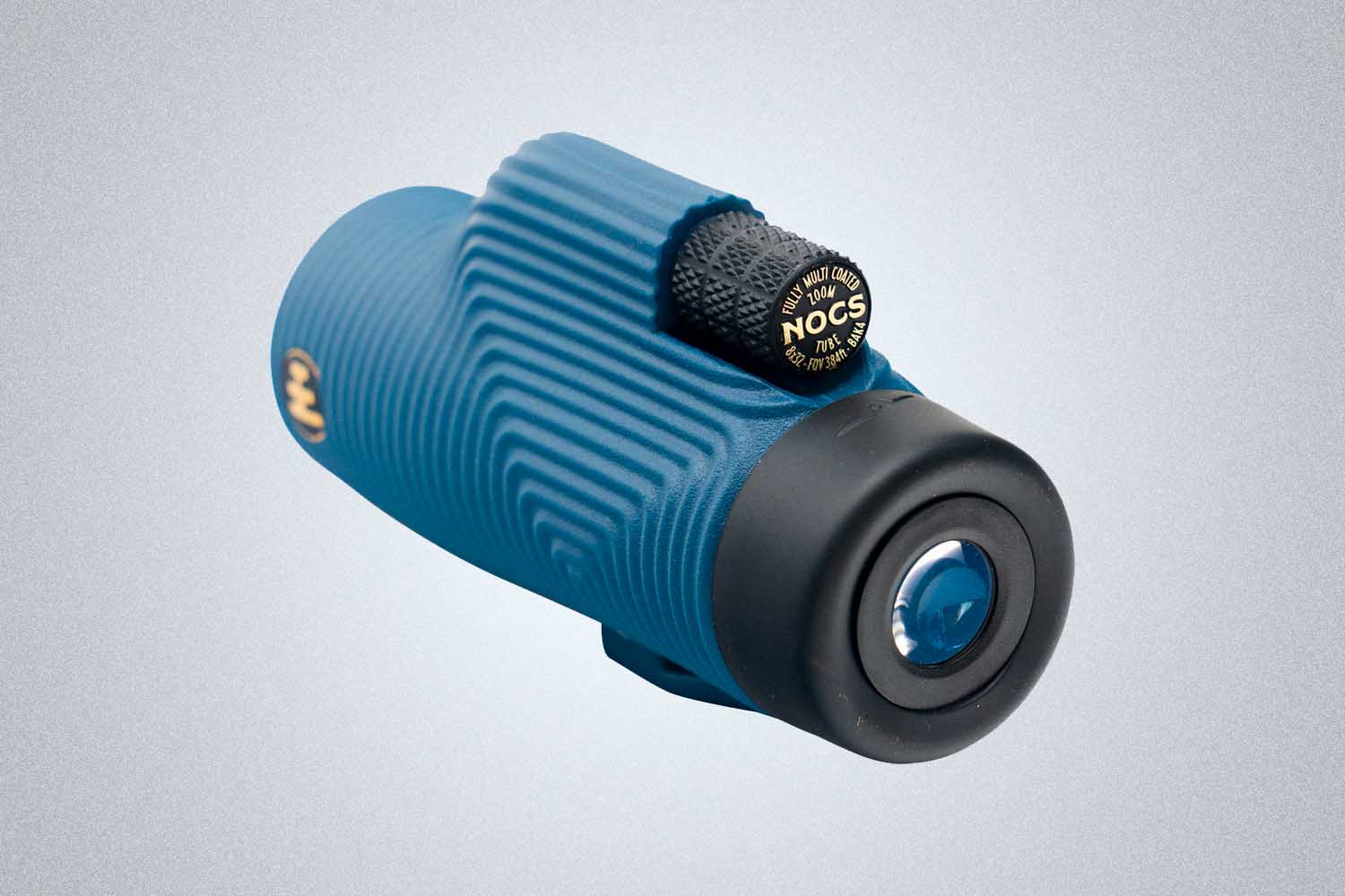 a single eye binocular device in light blue from Nocs on a grey background 