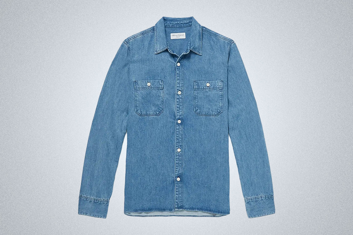 a light blue Officine Generale tencil snap shirt from Mr. Porter on a grey background