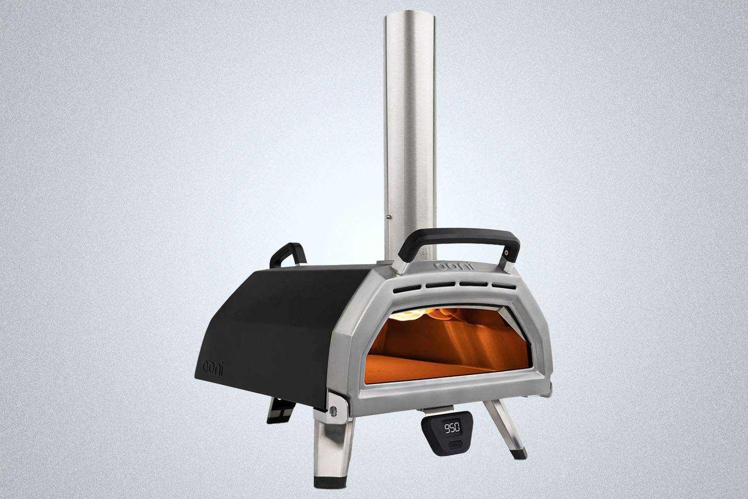 An Ooni pizza oven on a grey background