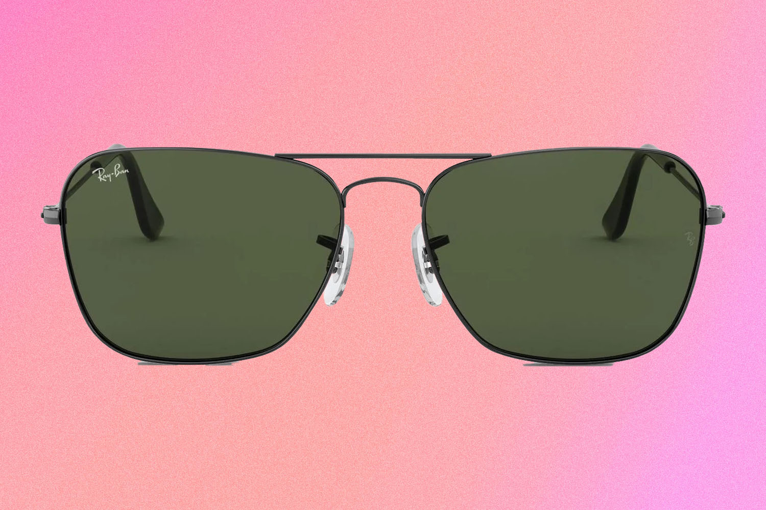 A pair of Ray-Ban Caravan RB3136 green-lensed aviator sunglasses on a pink and red background.