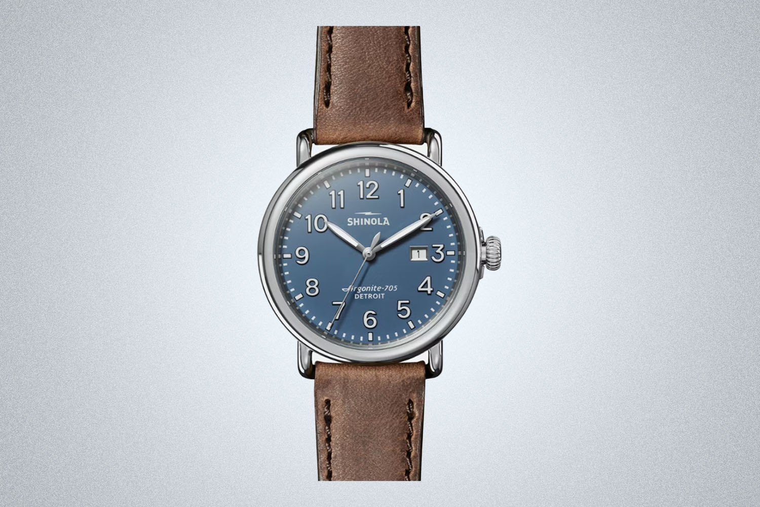a blue-faced leather strapped brown Shinola watch
