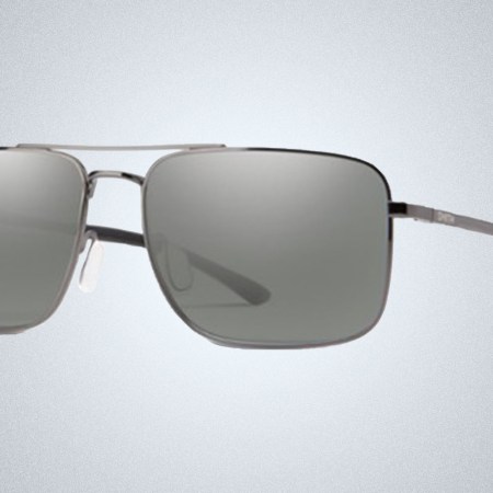 a pair of sliver Smith sunglasses on a grey background