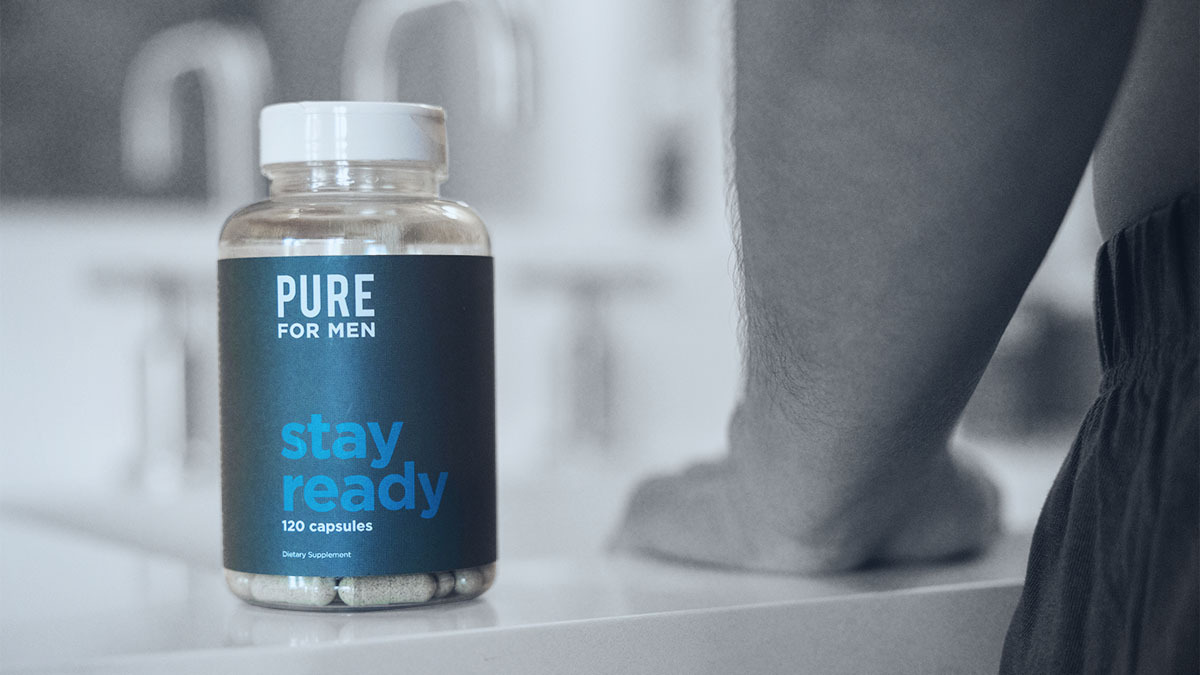 Photo shows a bottle of Pure for Men's Stay Ready Fiber supplements on a bathroom countertop