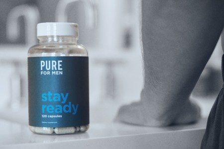 Photo shows a bottle of Pure for Men's Stay Ready Fiber supplements on a bathroom countertop