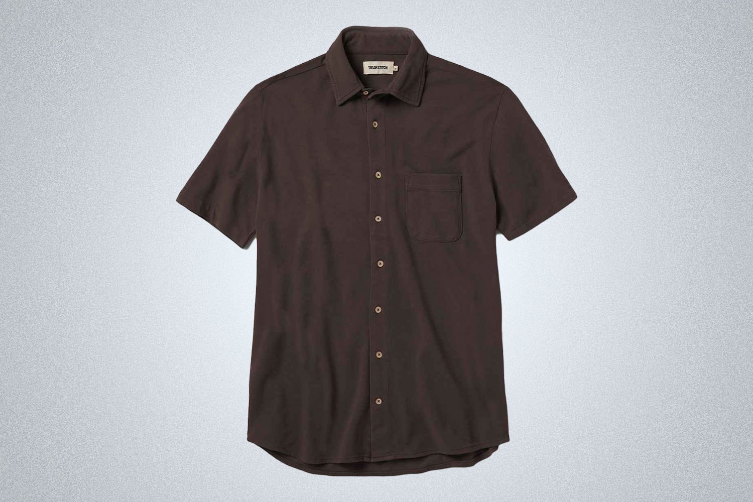 a brown short sleeve button up shirt from Taylor Stitch on a grey background