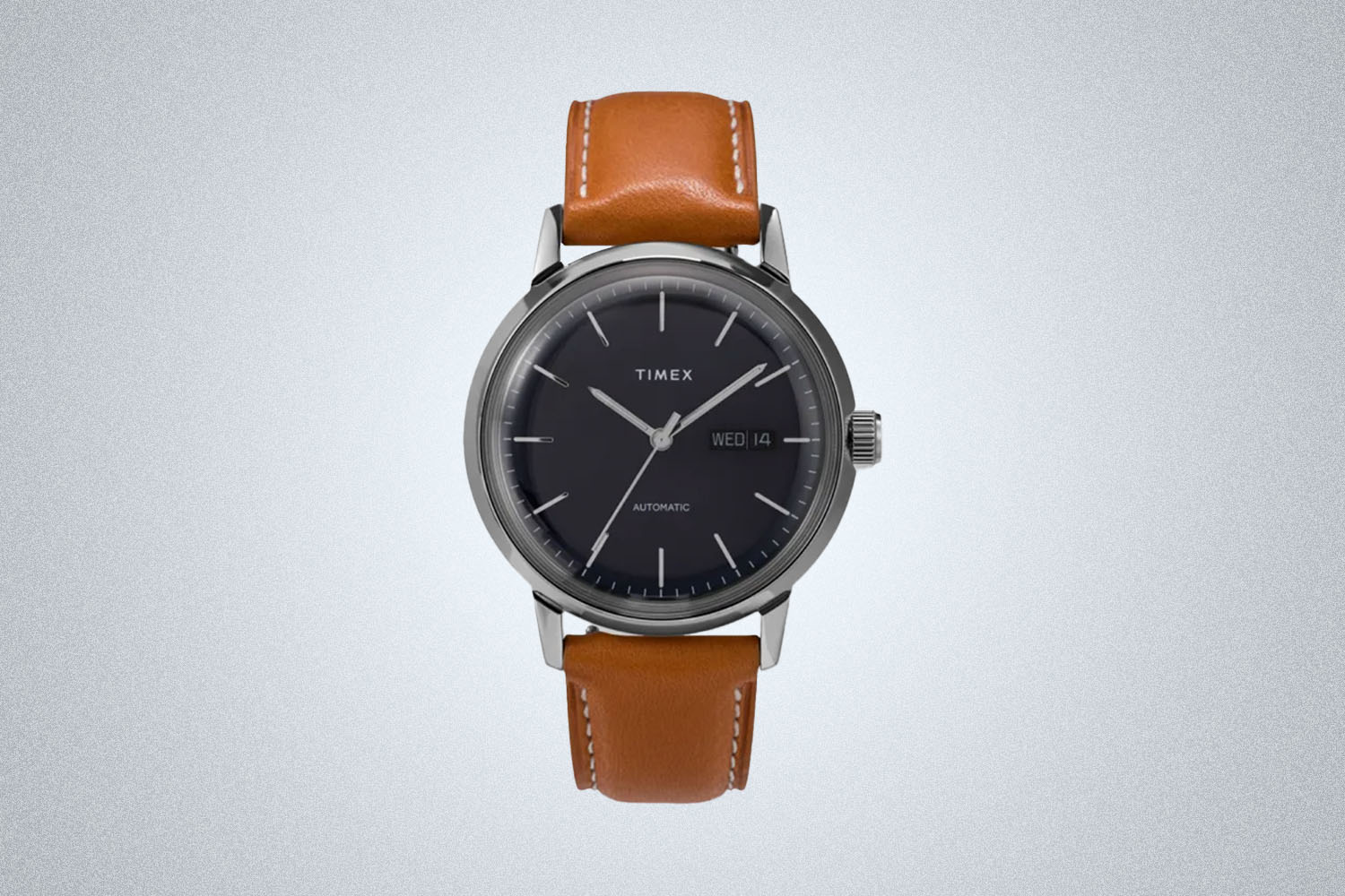 a navy-faced, brown leather Timex watch from Bespoke Post on a grey background
