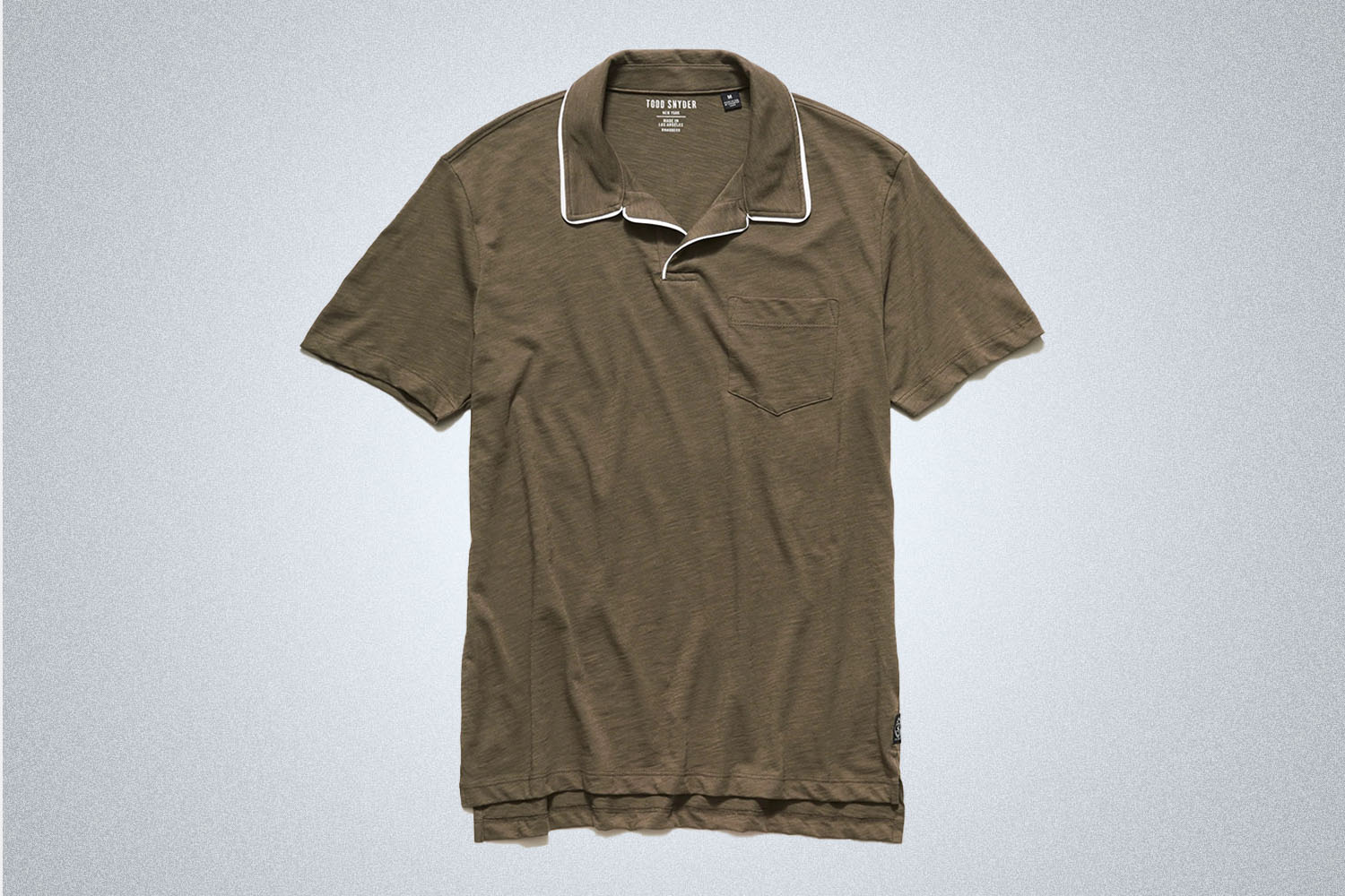 a green tipped polo from Todd Snyder on a grey background