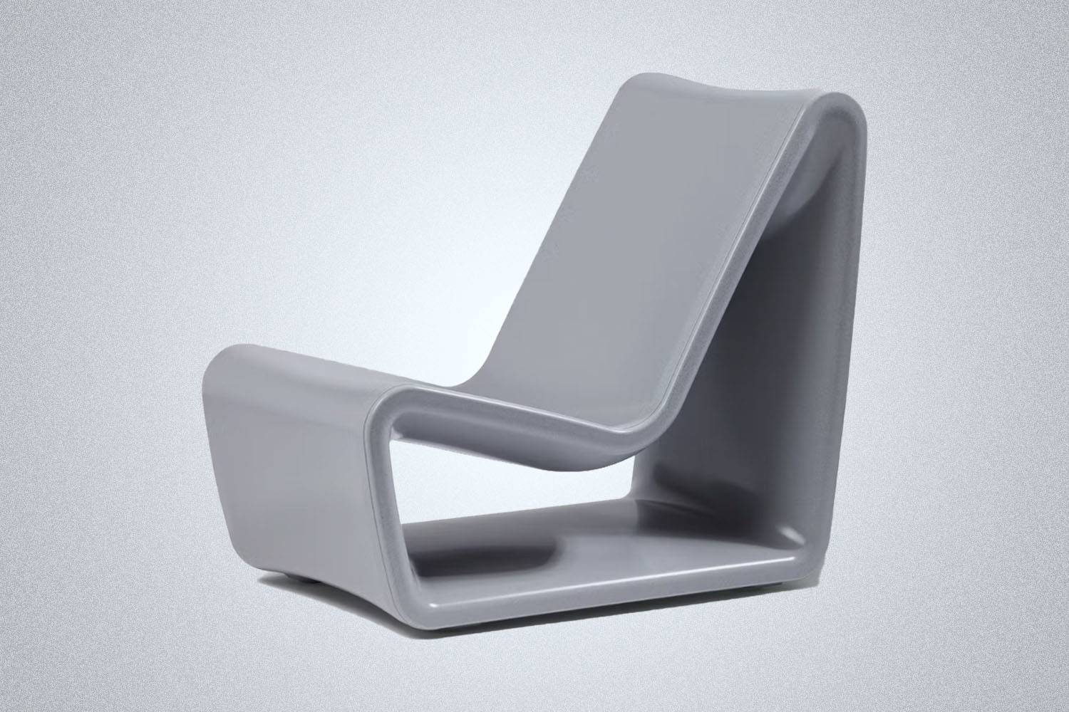 a concrete-colored outside chair on a grey background