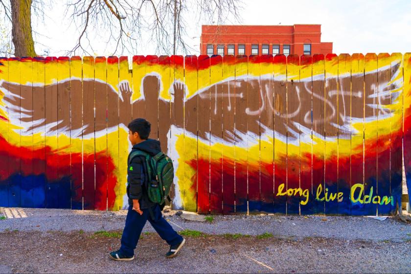 A little boy walks by an Adam Toledo memorial in Chicago, as shot by photographer Vashon Jordan Jr.