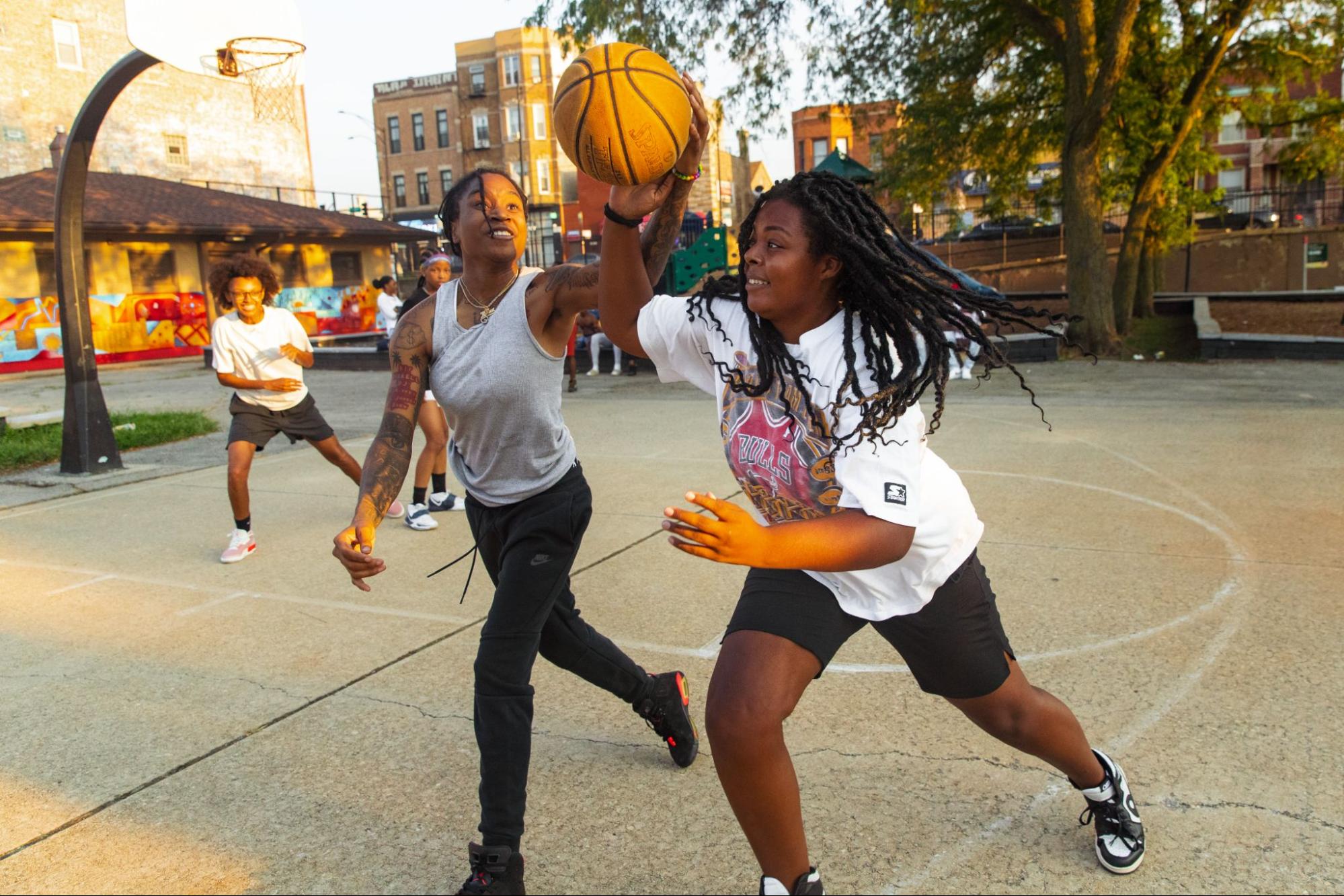 People playing basketball on a court in Chicago as photographed by Vashon Jordan Jr. for Black History Month