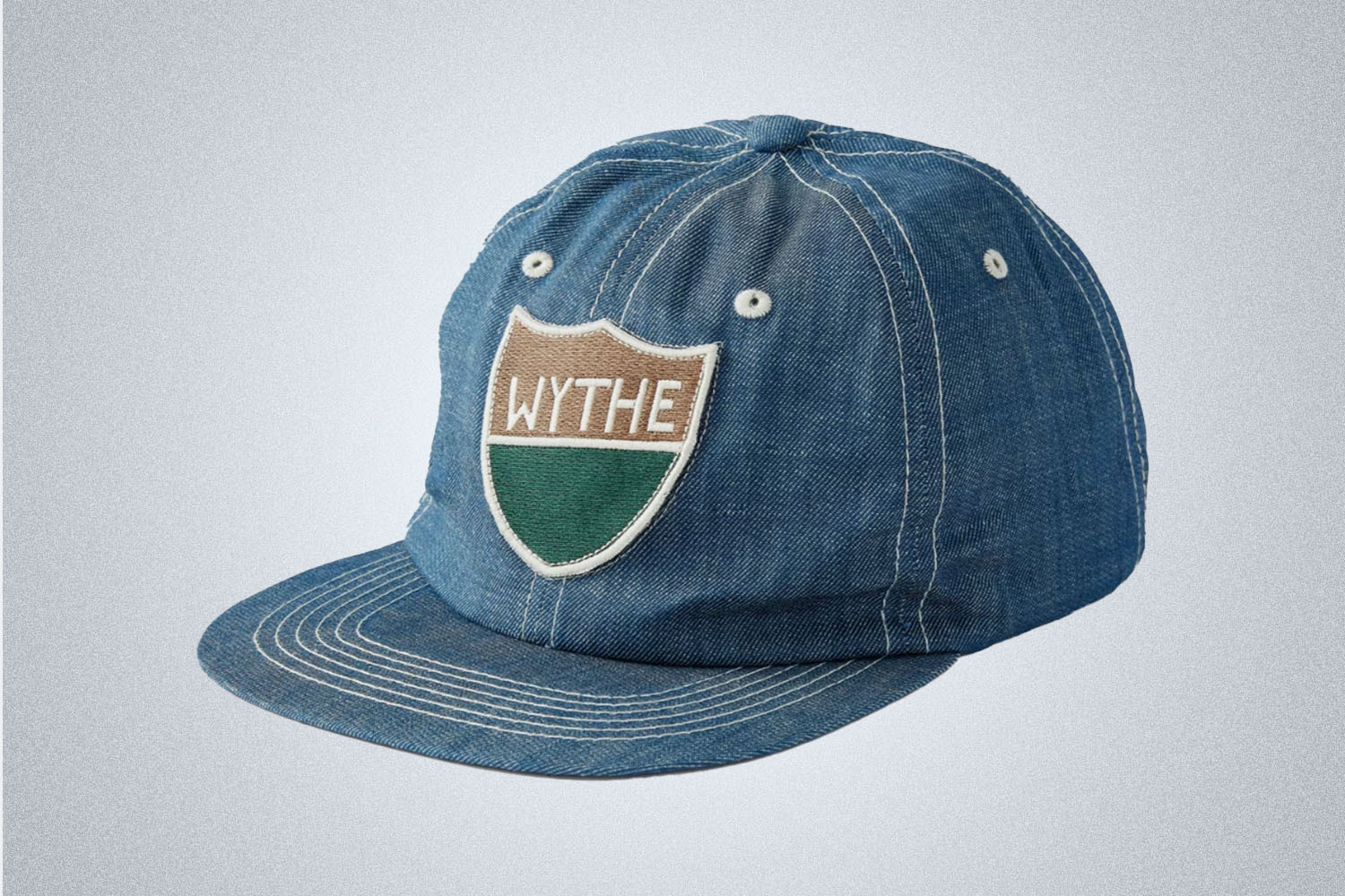 a blue denim-colored Whthe hat on a grey background