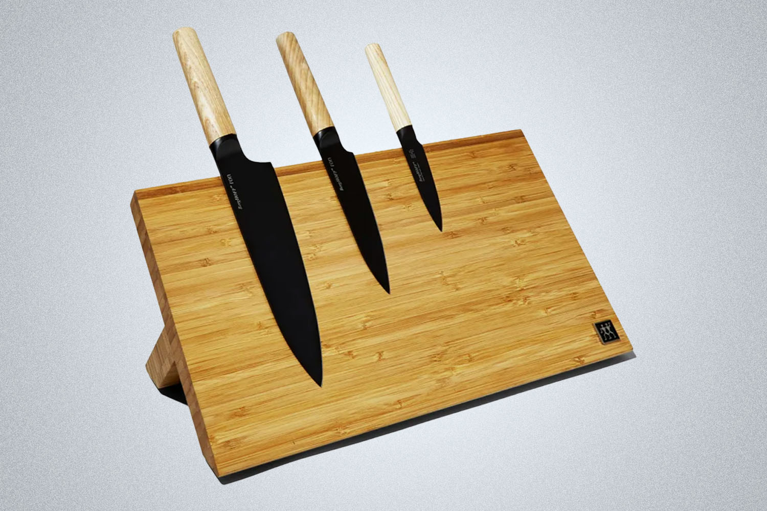 a Zwilling wooden magnetic cutting board from Bespoke Post on a grey background
