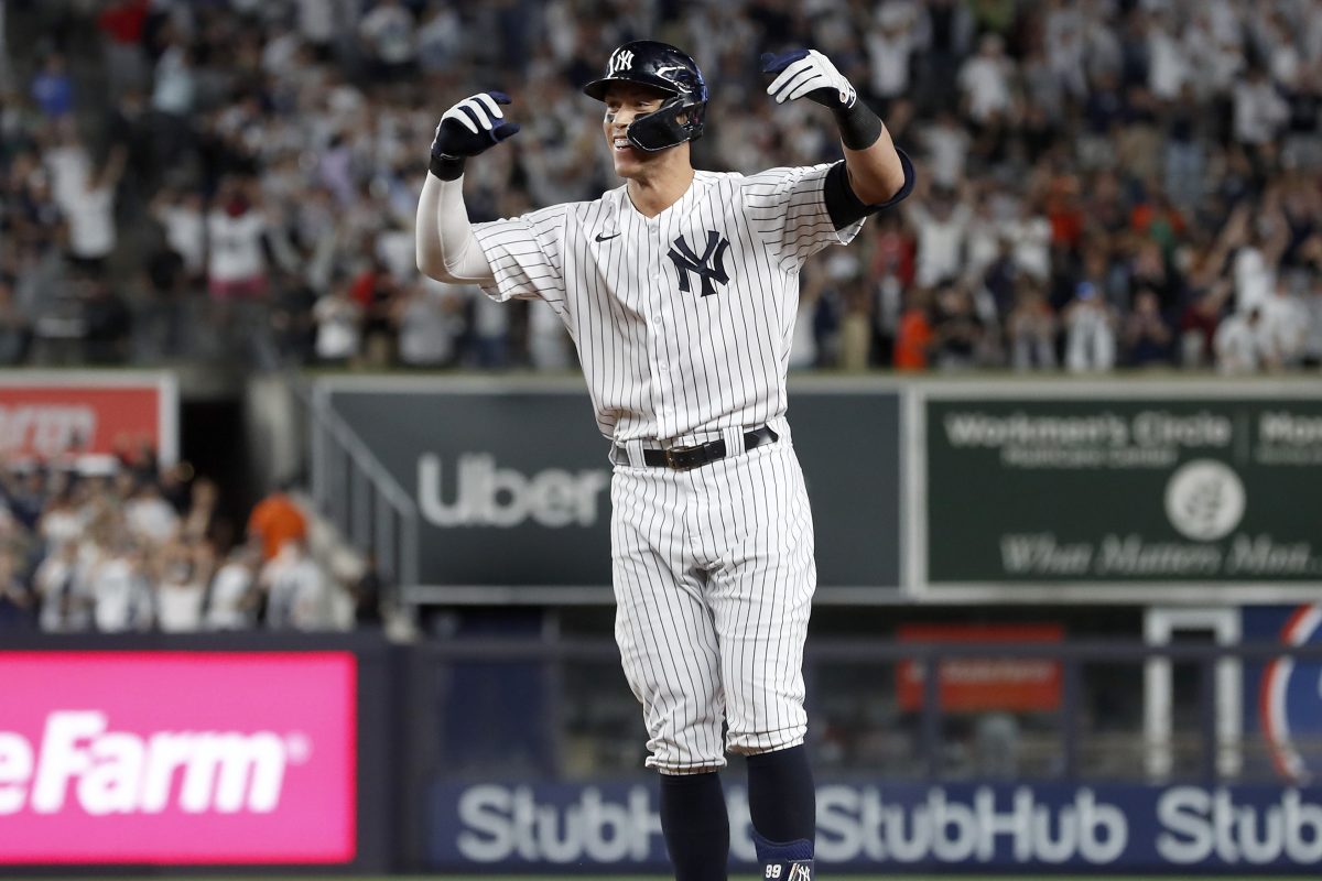 Aaron Judge of the New York Yankees celebrates his a game-winning base hit against the Astros