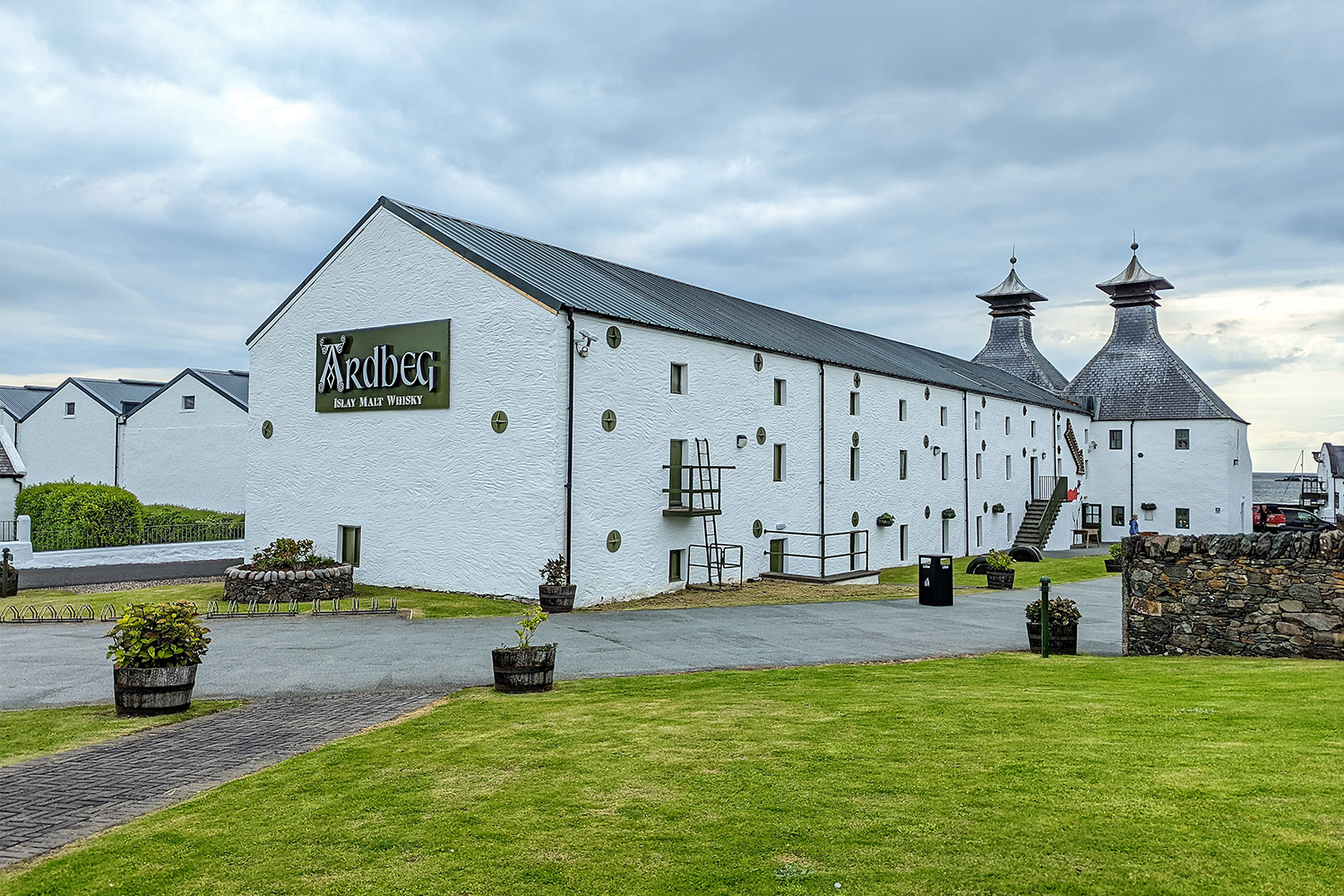 A white building that's part of the Ardbeg Scotch whisky distillery on the island of Islay, Scotland