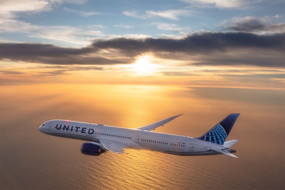 United Airlines aircraft during flight with a sunset over the ocean in the background. We take a look at the best new routes out of Chicago's O'Hare and Midway airports.