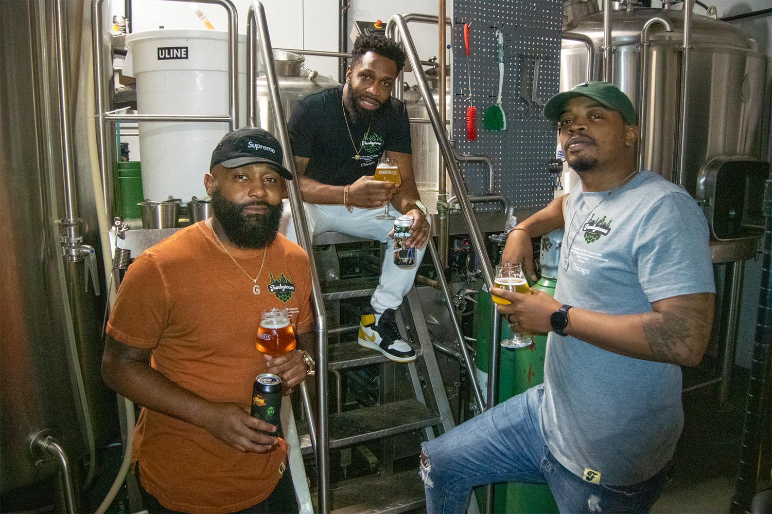 Richard Bloomfield, Zachary Day and Gregory Williams of Funkytown Brewery next to their beer-making area