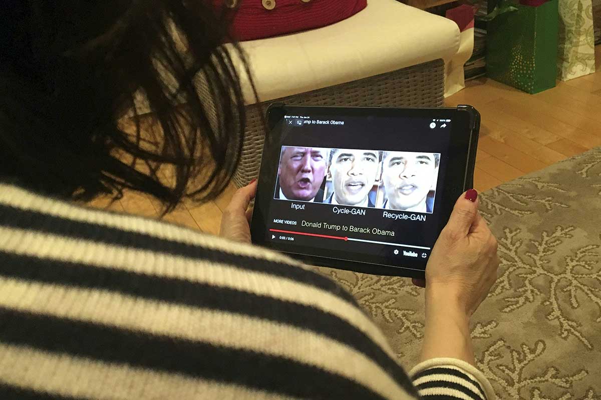 A woman in Washington, DC, views a manipulated video on January 24, 2019, that changes what is said by President Donald Trump and former president Barack Obama, illustrating how deepfake technology can deceive viewers. - "Deepfake" videos that manipulate reality are becoming more sophisticated and realistic as a result of advances in artificial intelligence, creating a potential for new kinds of misinformation with devastating consequences