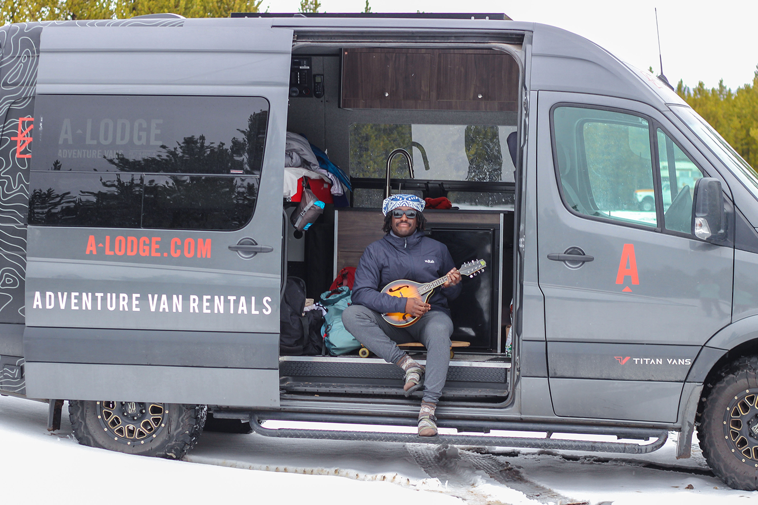 Writer and adventurer Joe Kanzangu sits in an A-Lodge adventure van