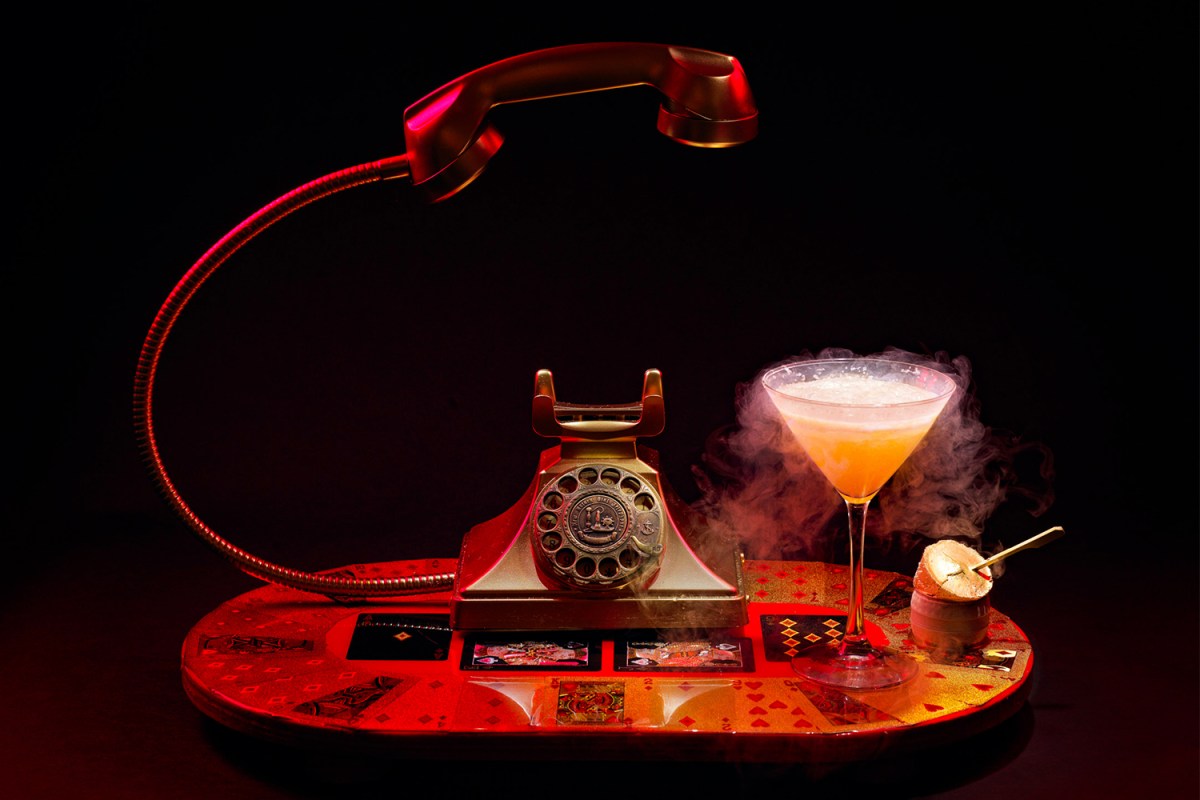 The Money Talks cocktail at Barton G, featuring a golden phone suspended in the air