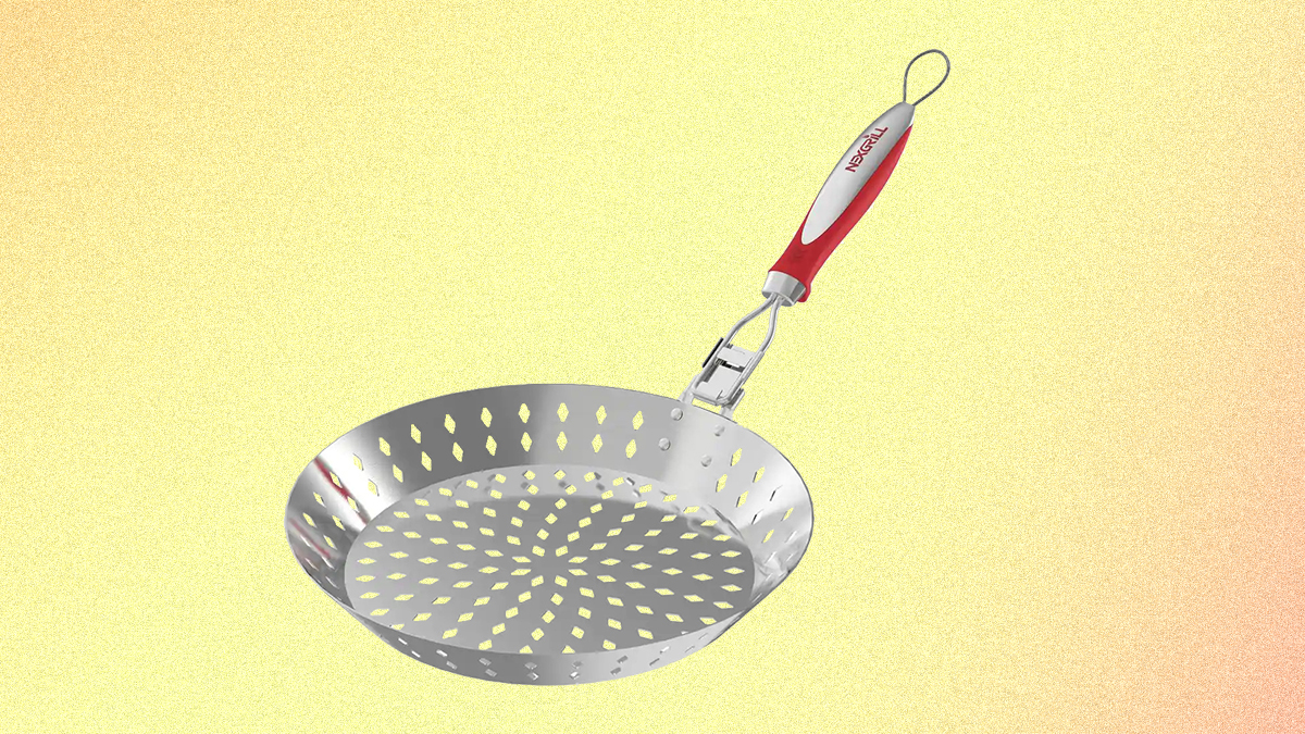 A grilling skillet from Nexgrill with a red handle and holes in the stainless steel basket, pictured on a yellow background.