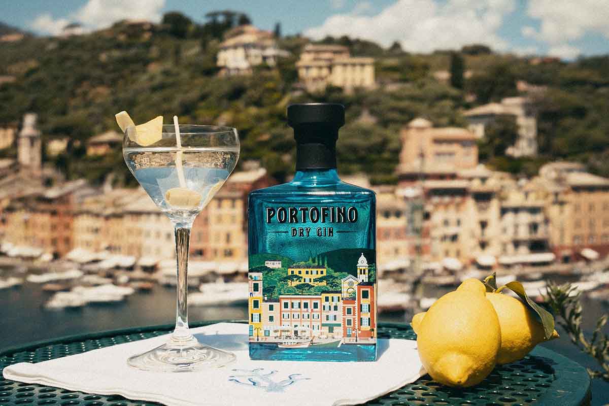 Portofino Dry Gin on a table with a G&T and a lemon -- Portofino is one of 10 good gins from around the globe