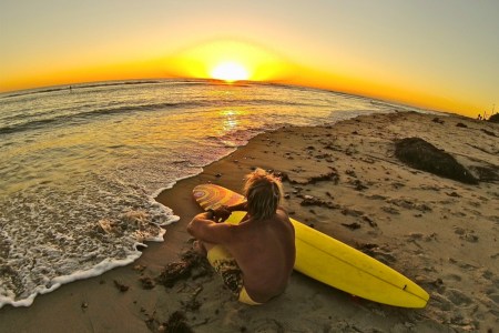 Surfing legend Chuck Patterson on the beach at sunset. He recently told us about his favorite places to surf in California.