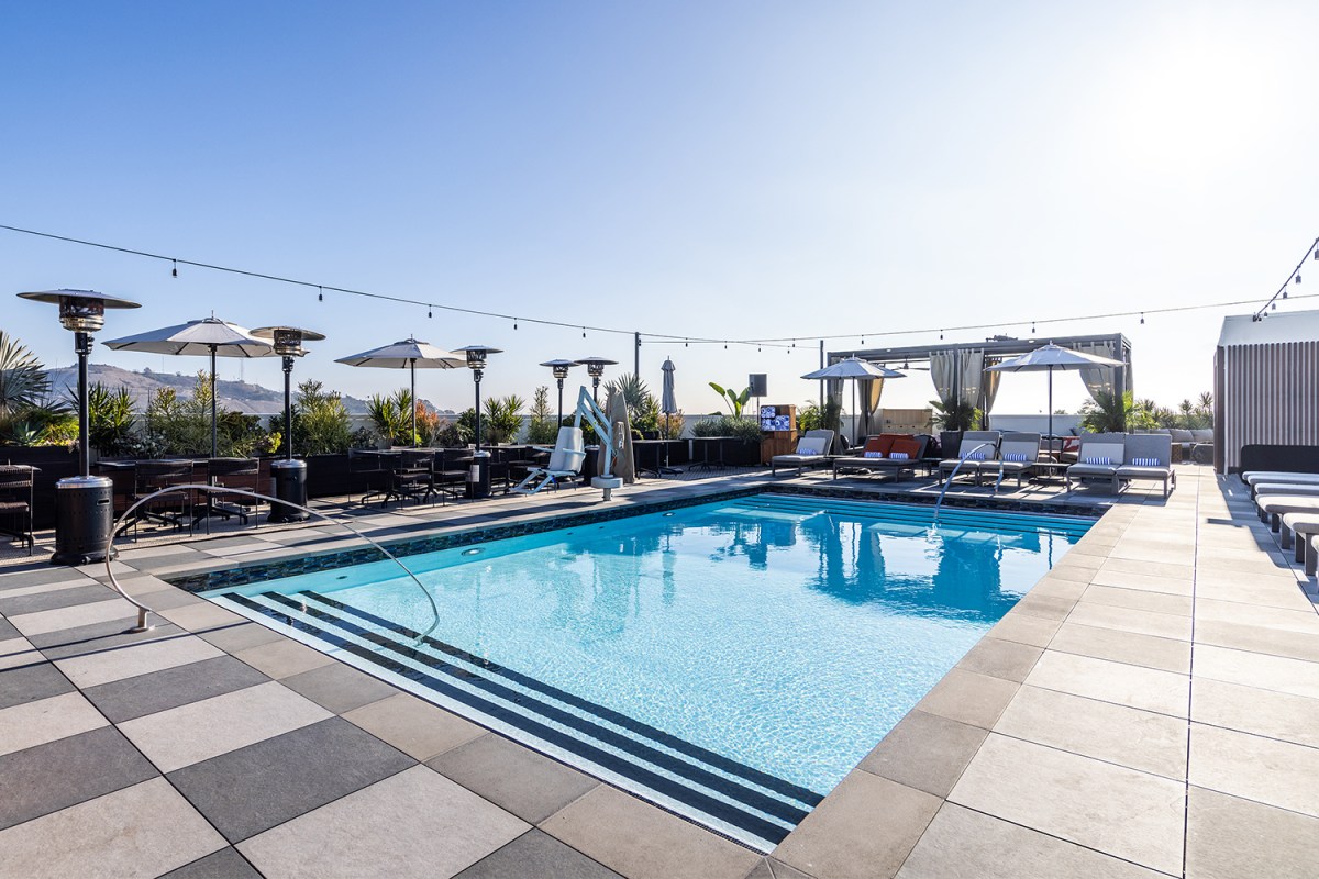 The rooftop pool at The Shay in Los Angeles during the day under a blue sky