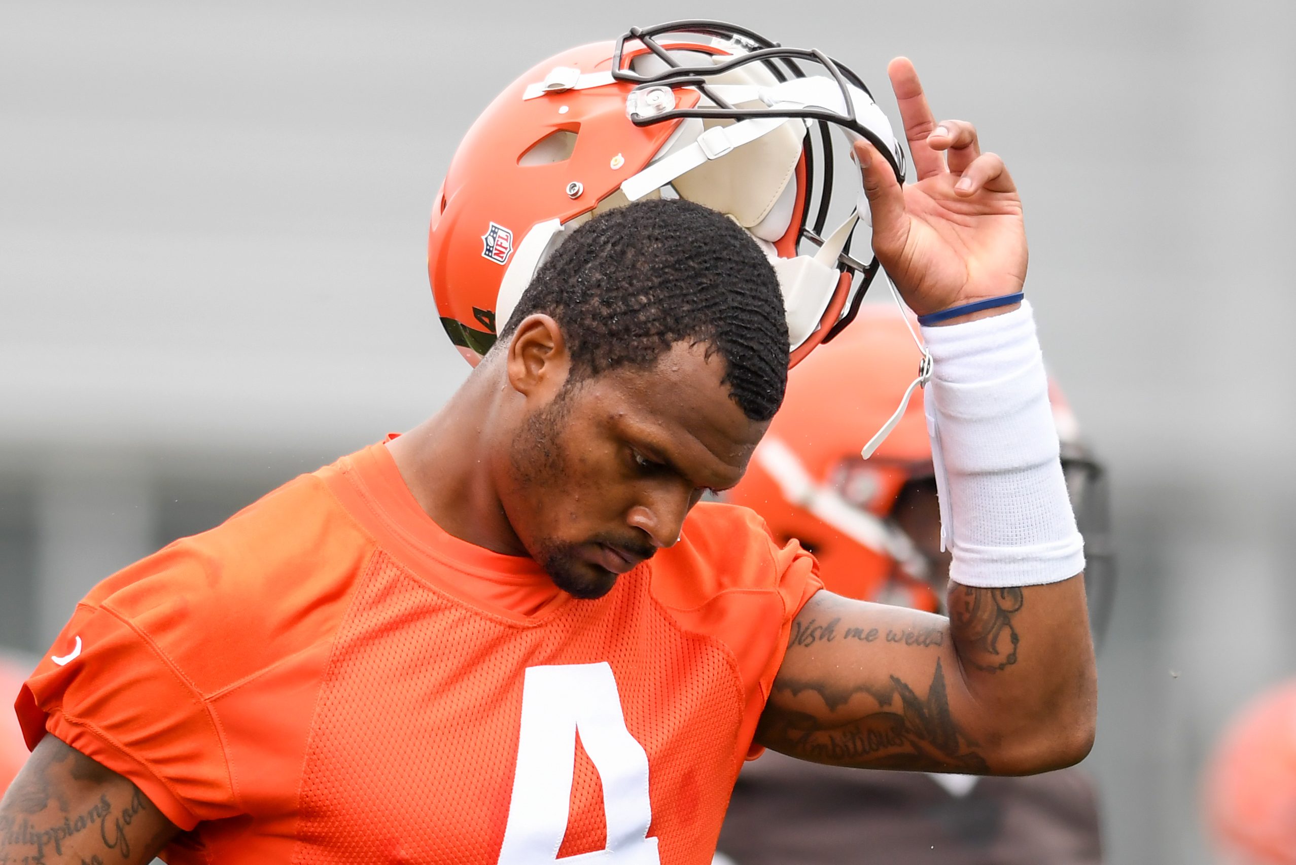 Deshaun Watson of the Browns takes off his helmet as he warms up