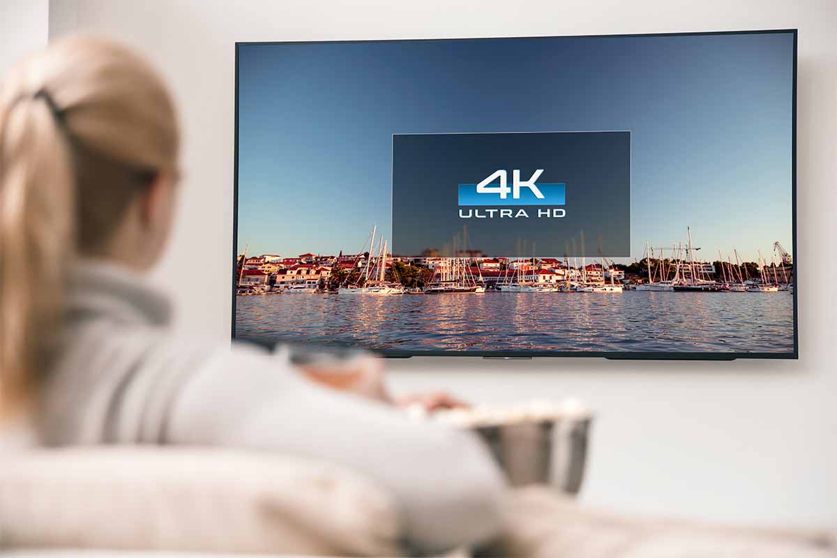 A woman watching 4K TV. New CGI-heavy movies may look bad on 4K TVs.