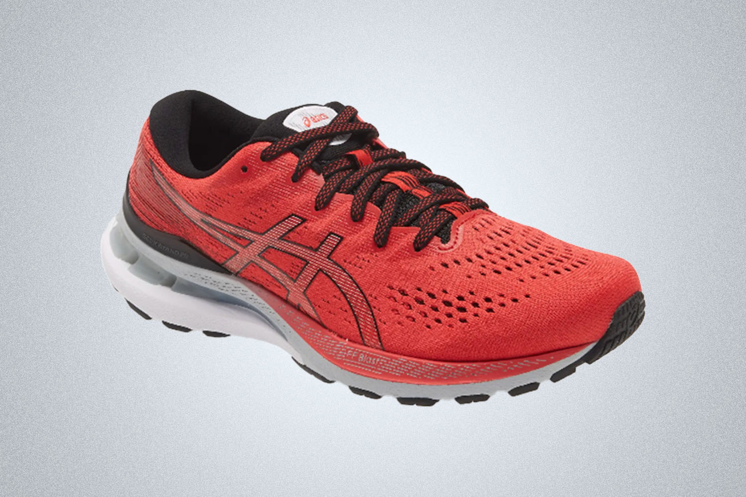 a red running sneaker from ASICS on a grey background