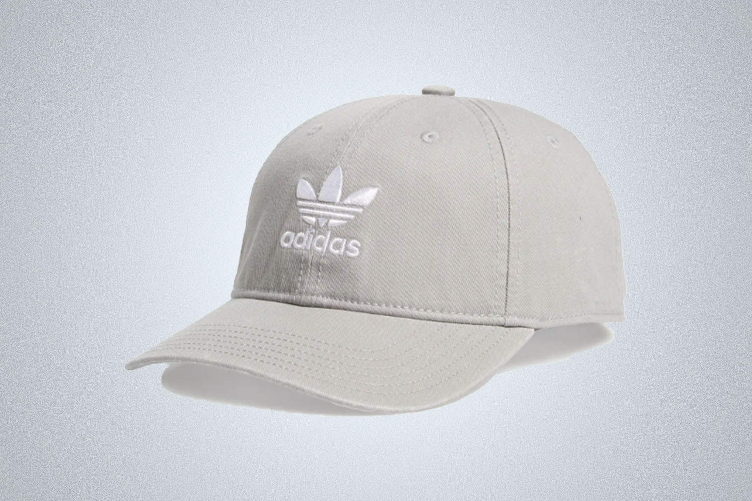 a grey adidas logo cap on a grey background