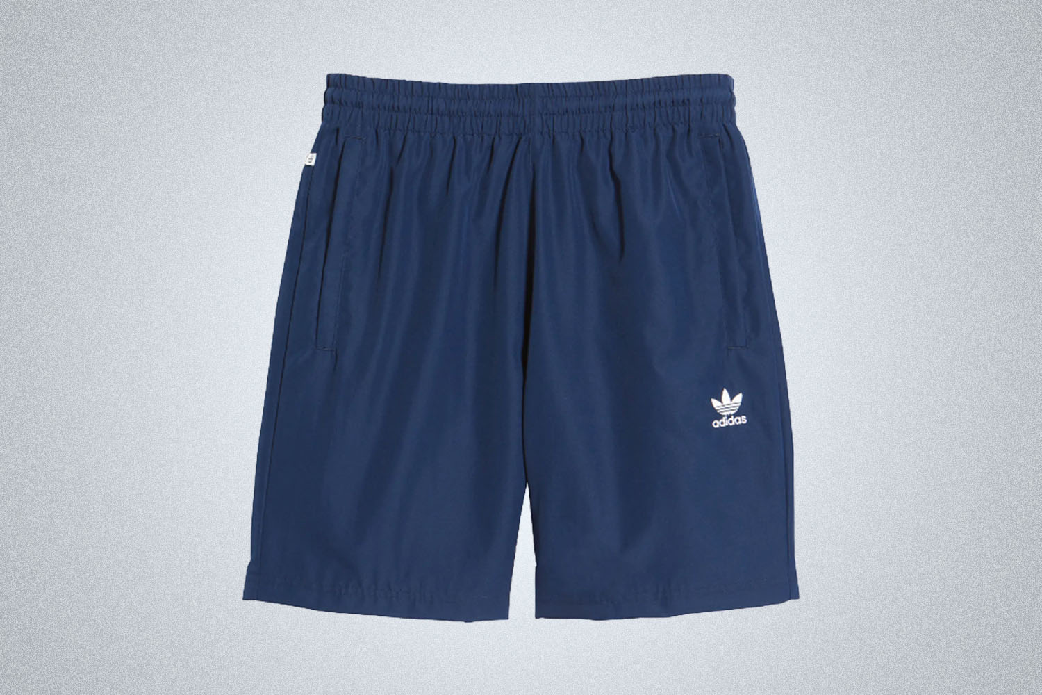 a pair of blue adidas shorts on a grey background