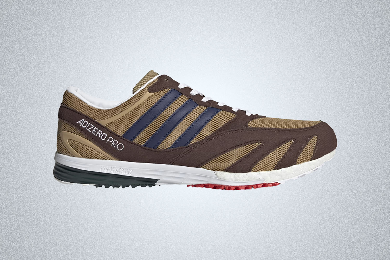 a brown accented sneaker from Adidas x Noah on a grey background