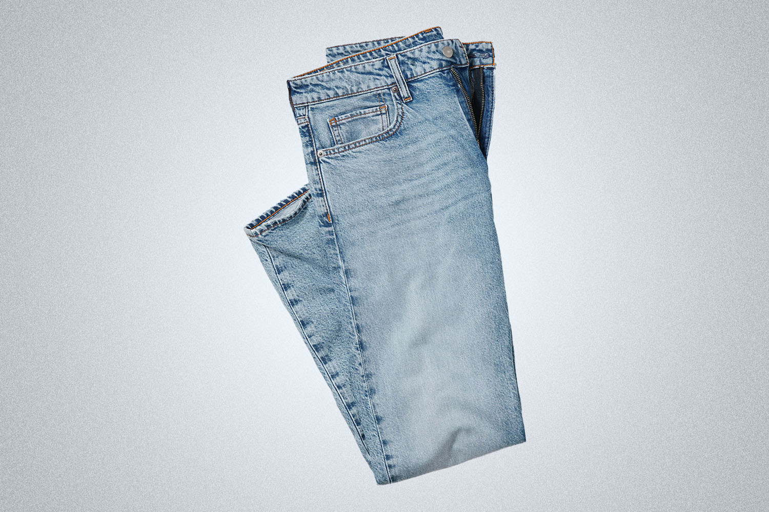 a pair of light washed folded jeans from Bonobos on a grey background