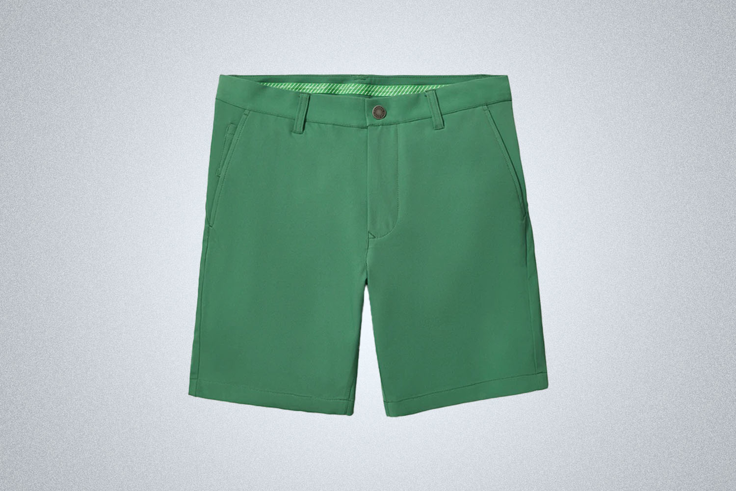 a pair of green golf shorts from Bonobos on a grey background