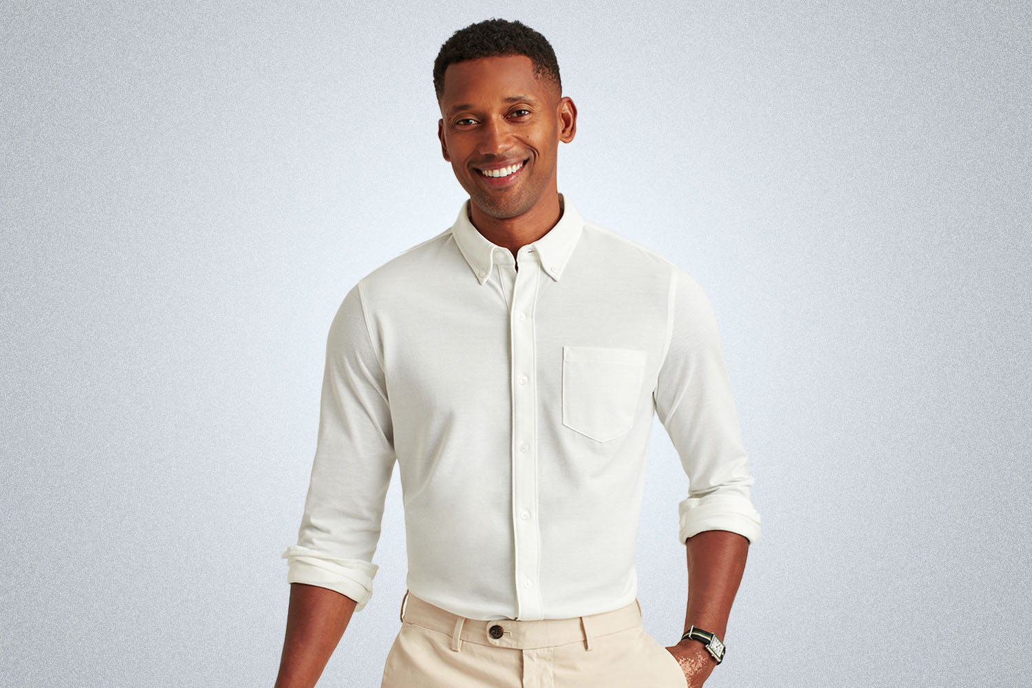 a model in a white knit Oxford shirt from Bonobos on a grey background
