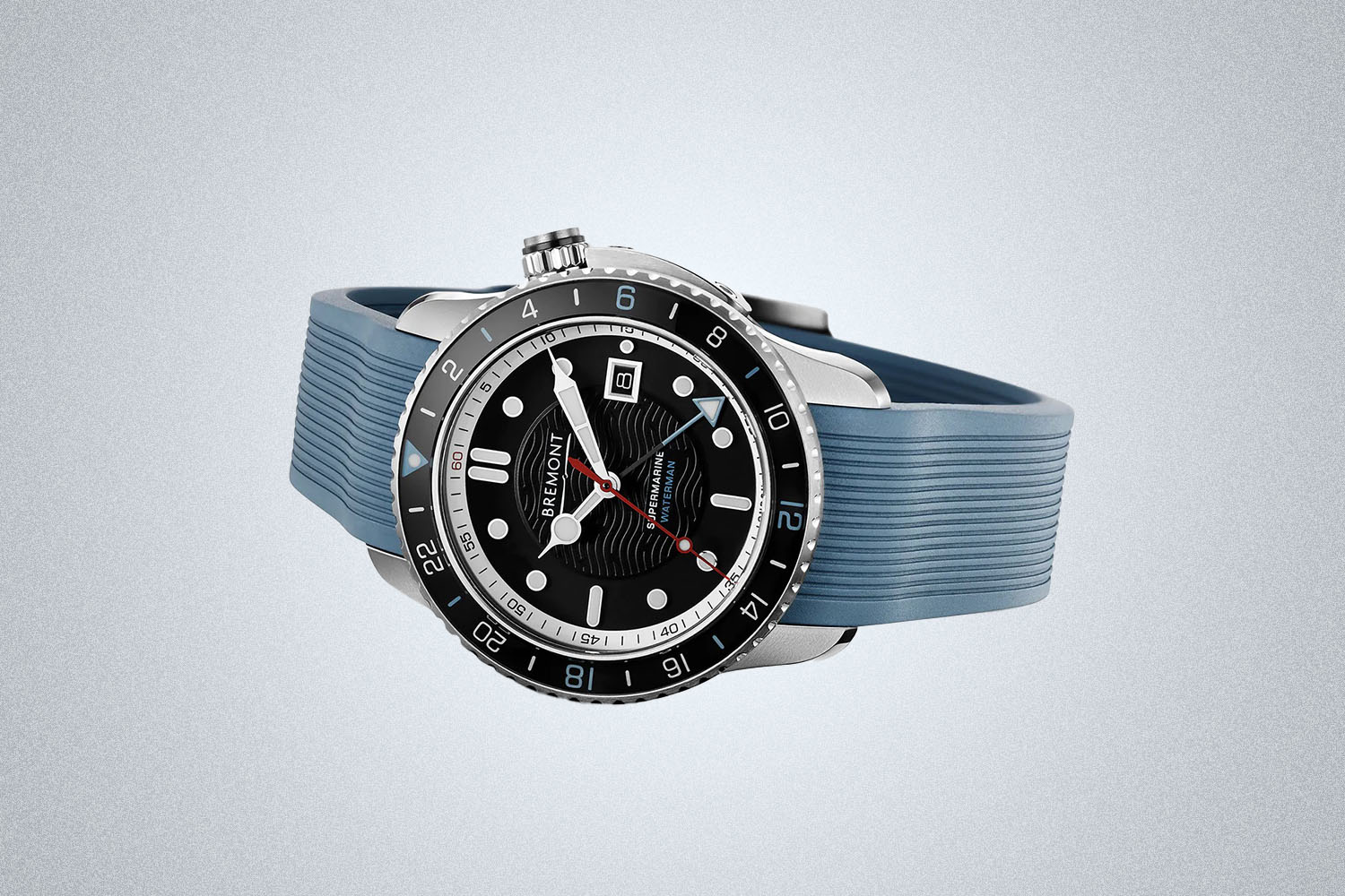 a blue strap stainless steel Bremont watch with a black dial on a gray background