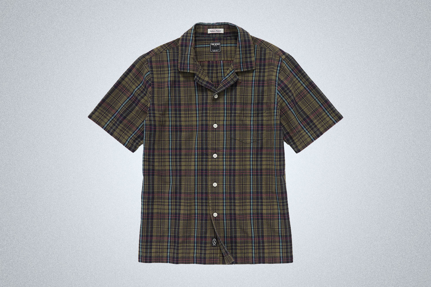 a checked green-black tee from Todd Snyder on a grey background