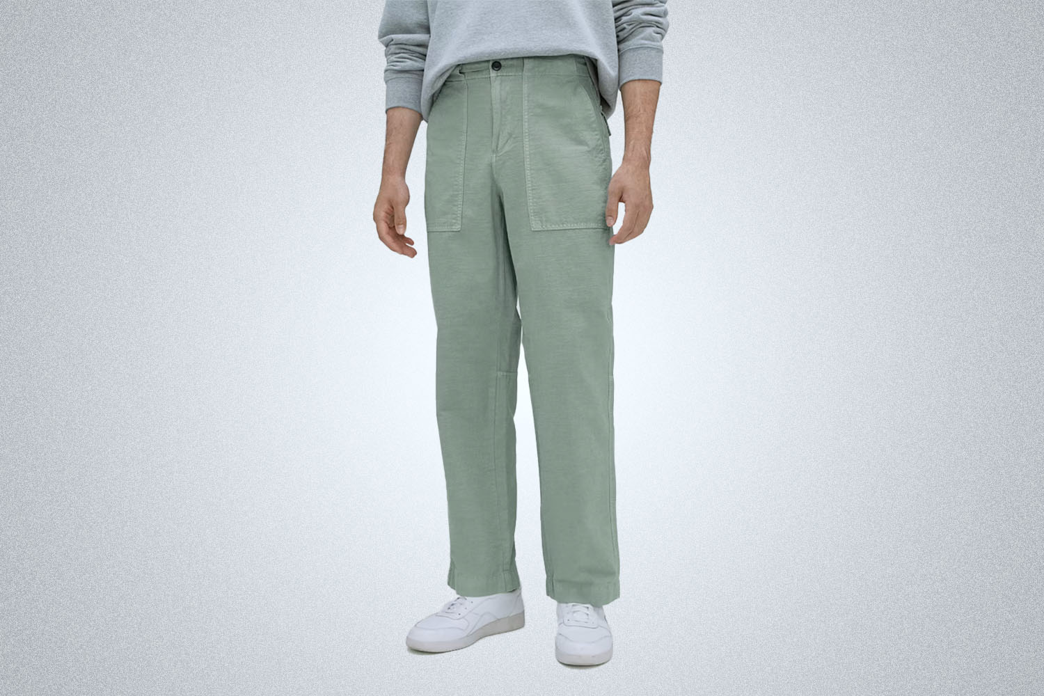a model in a pair of Everlane utility pants on a grey background
