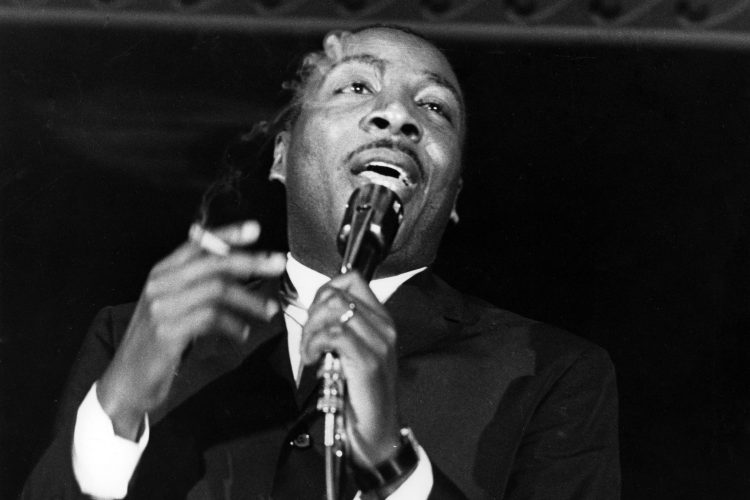 Comedian Dick Gregory performs onstage in circa 1961.