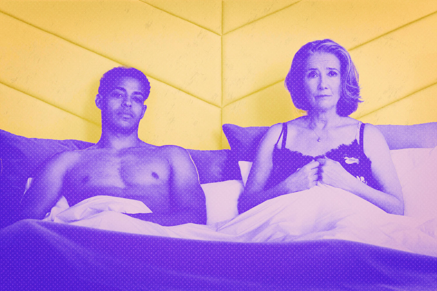 A still from "Good Luck to You Leo Grande" shows stars Emma Thompson (as Nancy Stokes) and Daryl McCormack (as Leo Grande) sitting side by side in bed.