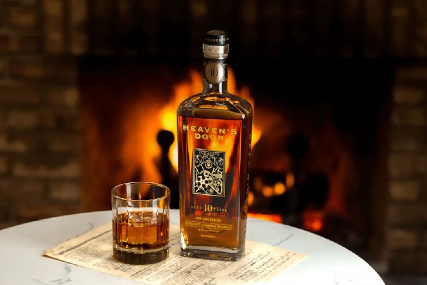 a bottle of Heaven's Door Bourbon and a glass in front of a fireplace
