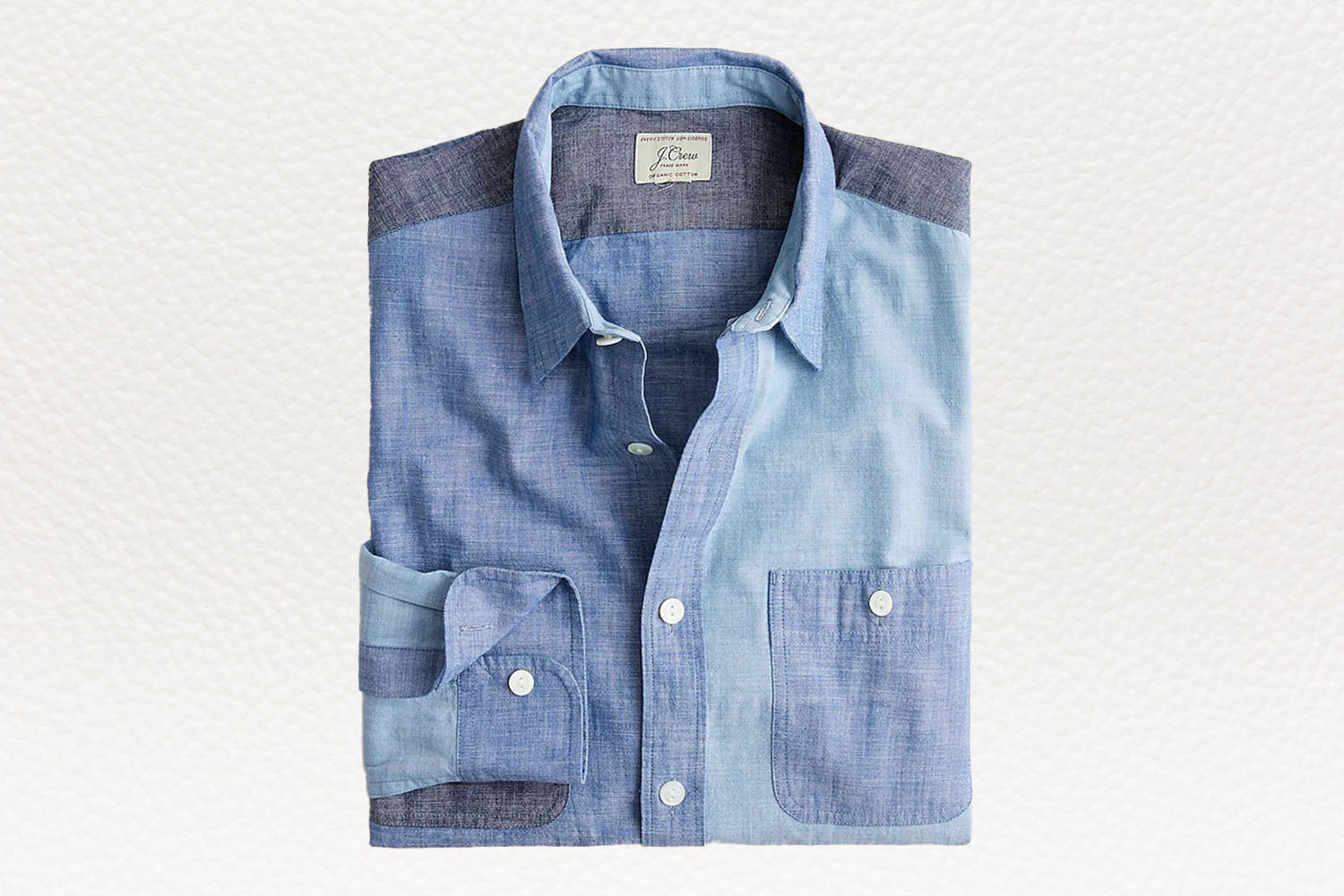 a blue mix and match chambray shirt from J.Crew on a white textured background
