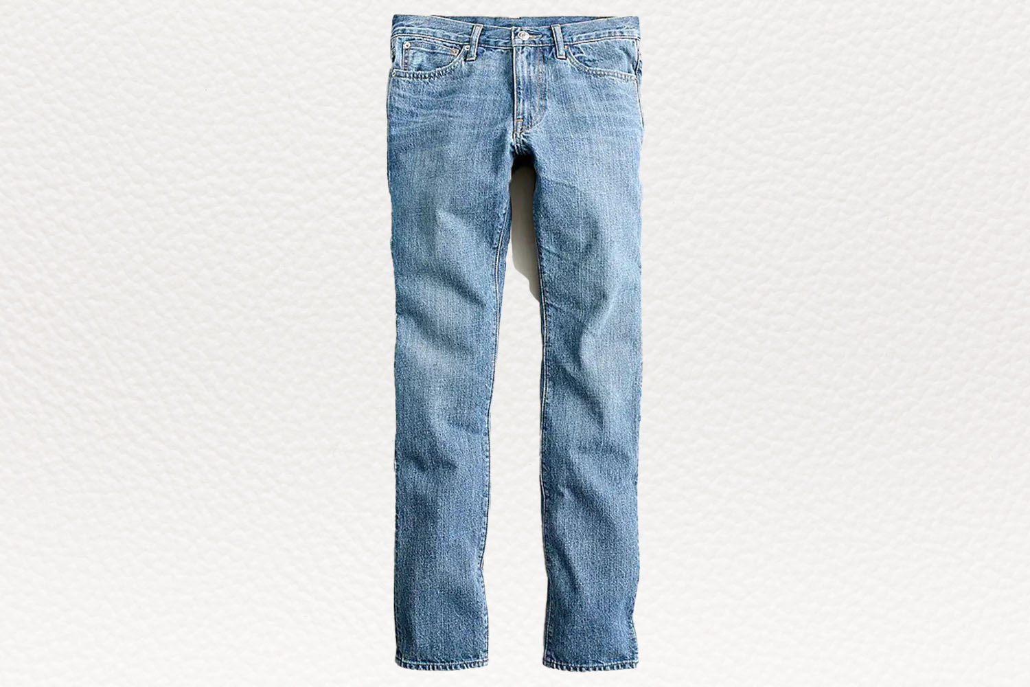 a pair of lightwash J.Crew jeans on a white textured background