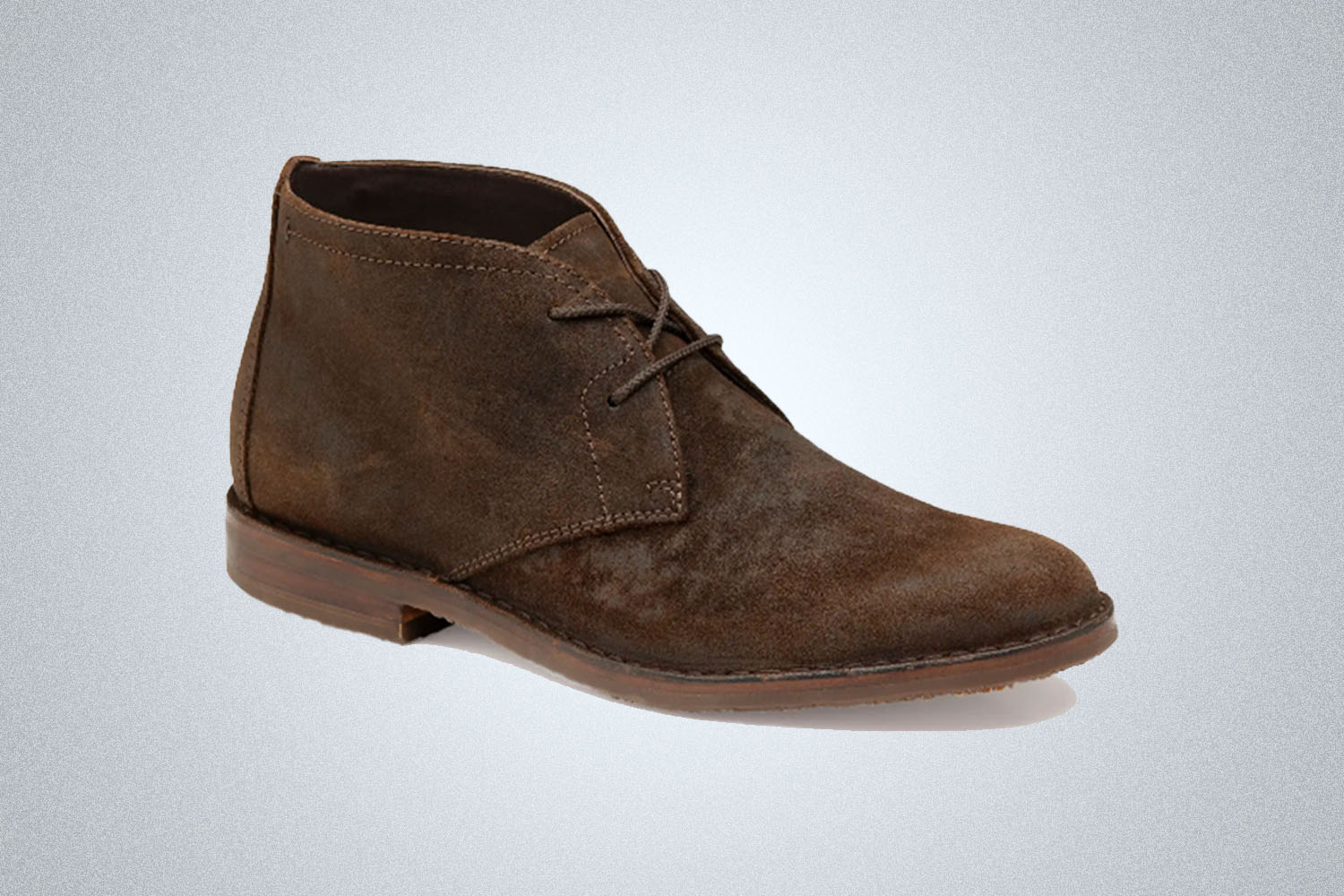 a pair of brown suede chukka boots from Johnston and Murphy on a grey background