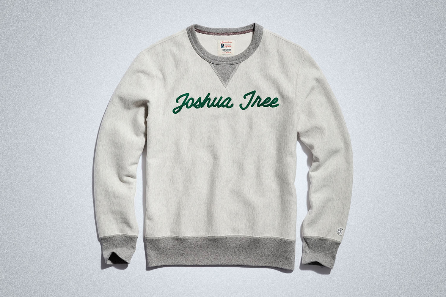 a grey "Joshua tree" sweater from Todd Snyder on a grey background