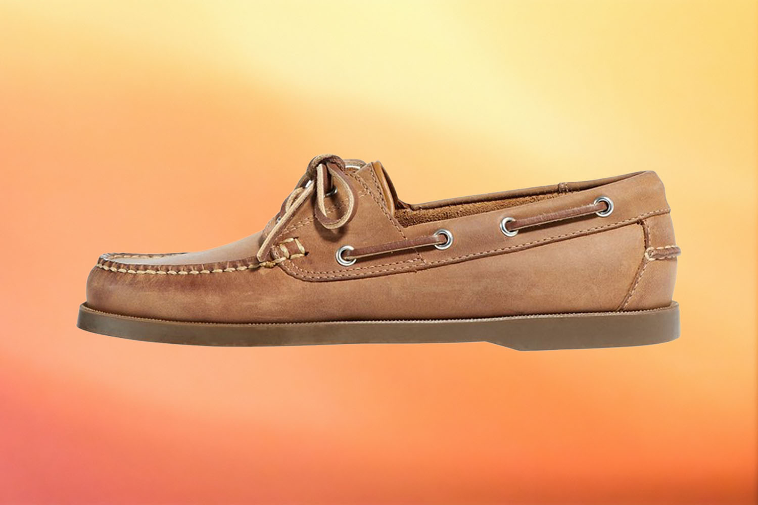 a tan leather boat shoe from L.L. Bean on a yellow-orange gradient background